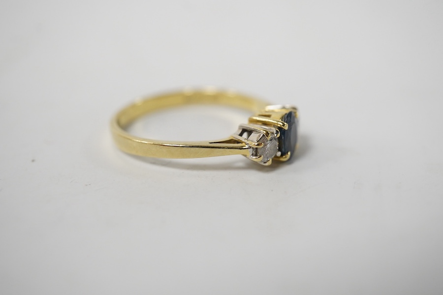 A modern 18ct gold, single stone sapphire and two stone diamond set ring, size Q, gross weight 3 grams. Condition - poor to fair